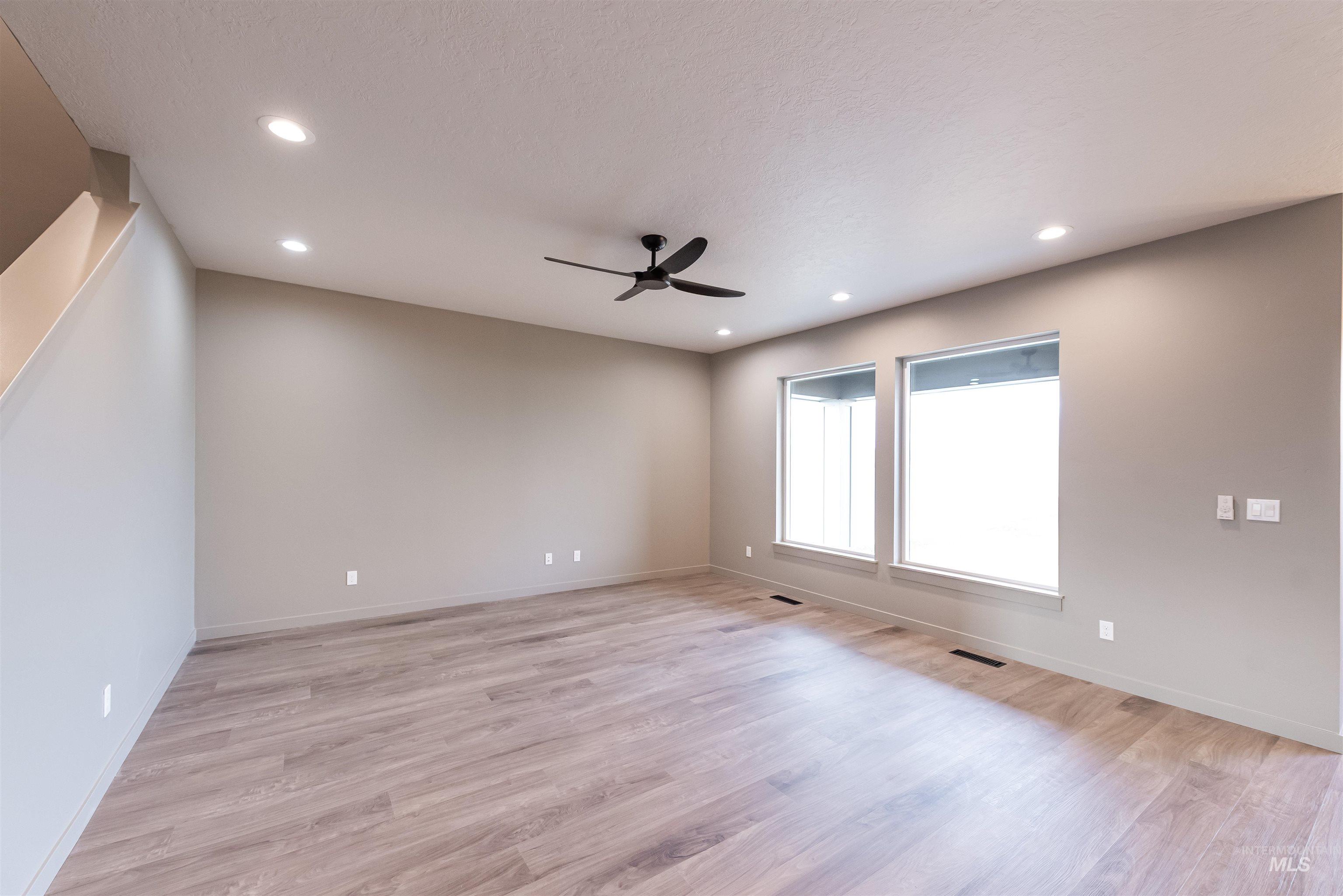 Empty room with light wood-style floors, recessed lighting, and a ceiling fan