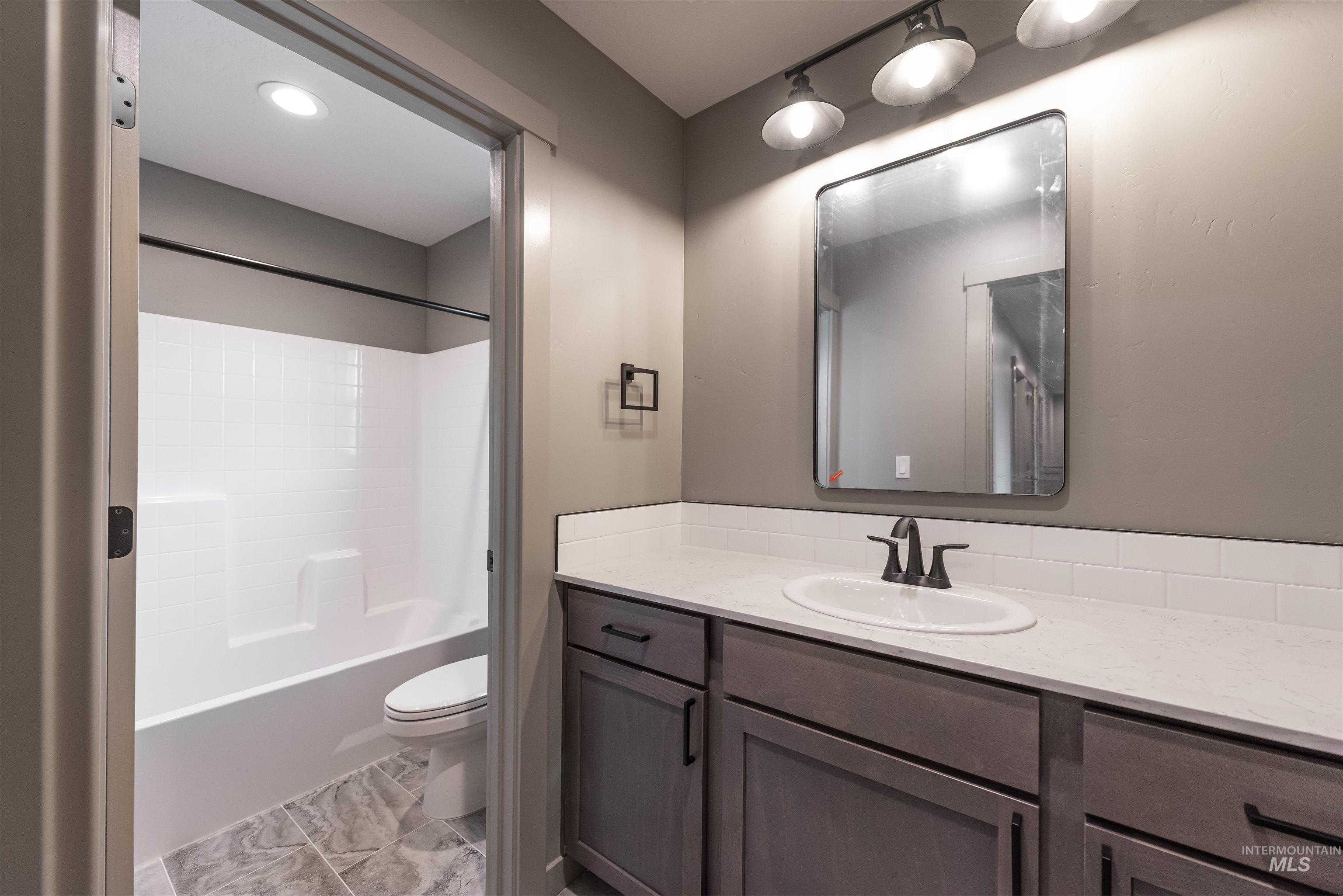 Full bathroom featuring vanity and tub / shower combination