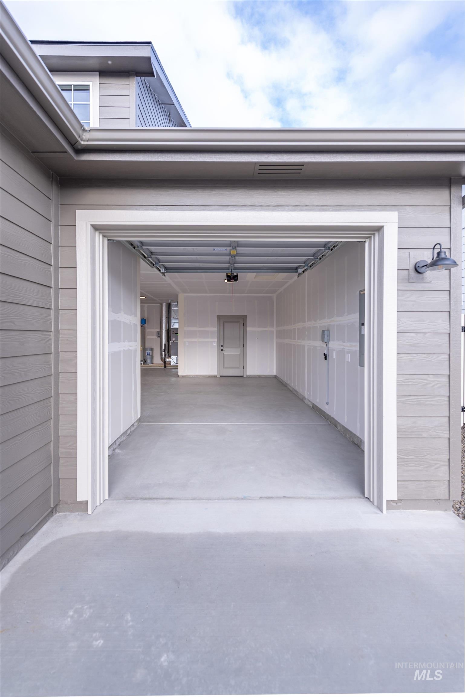 Garage featuring concrete driveway