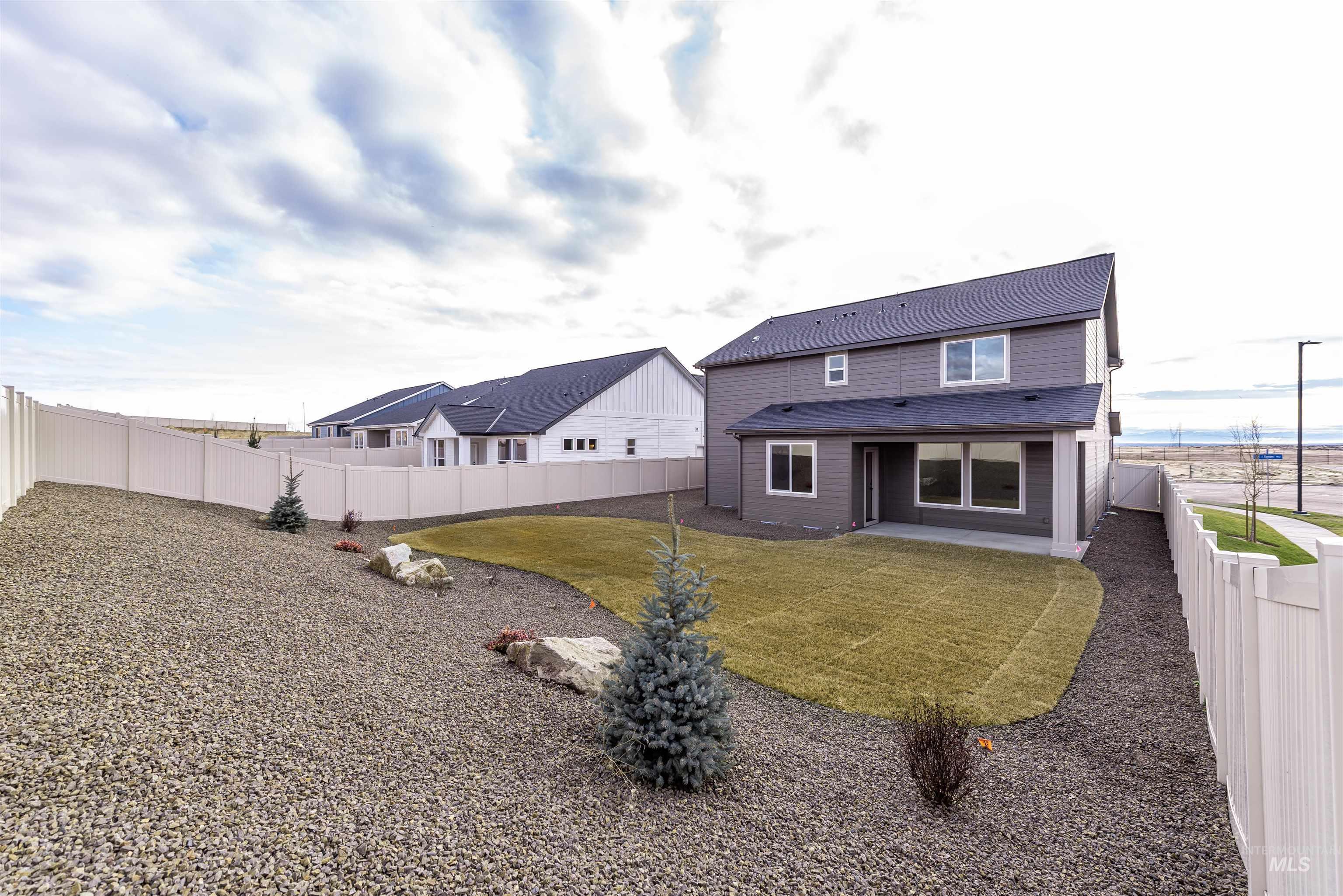 Rear view of property featuring a patio and a fenced backyard