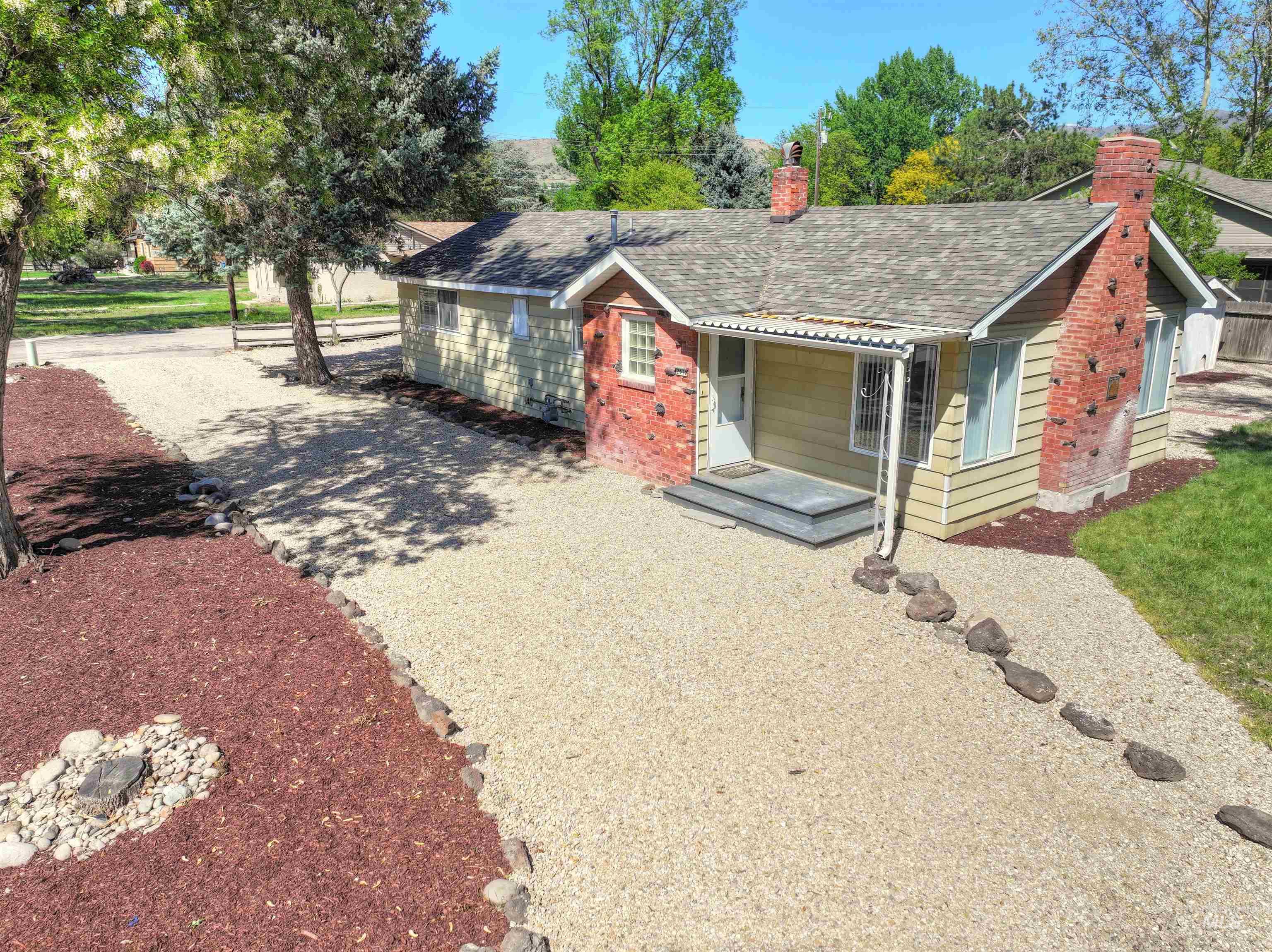 Bungalow with a chimney and a shingled roof