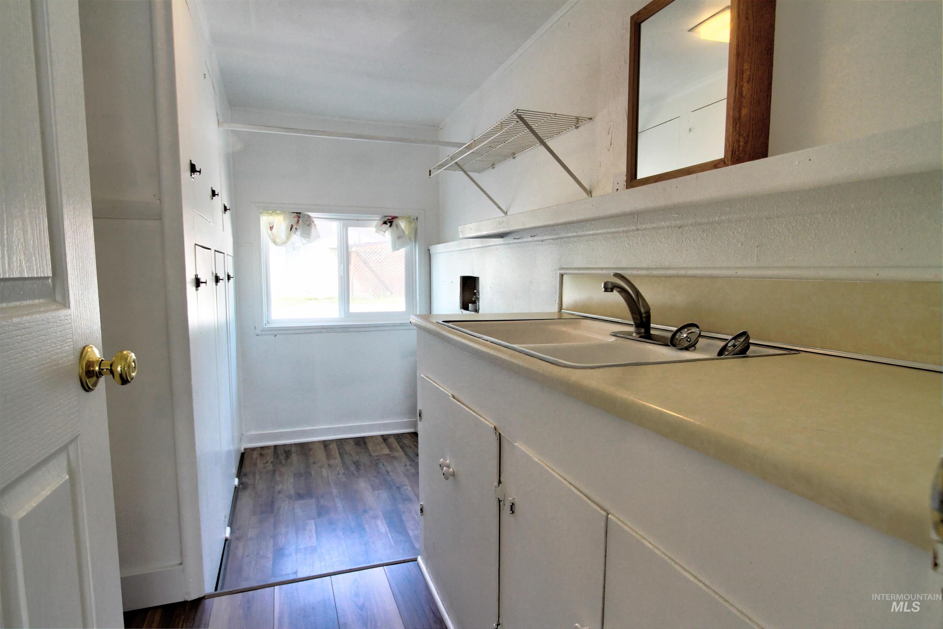 Laundry room featuring washer hookup and dark wood-type flooring