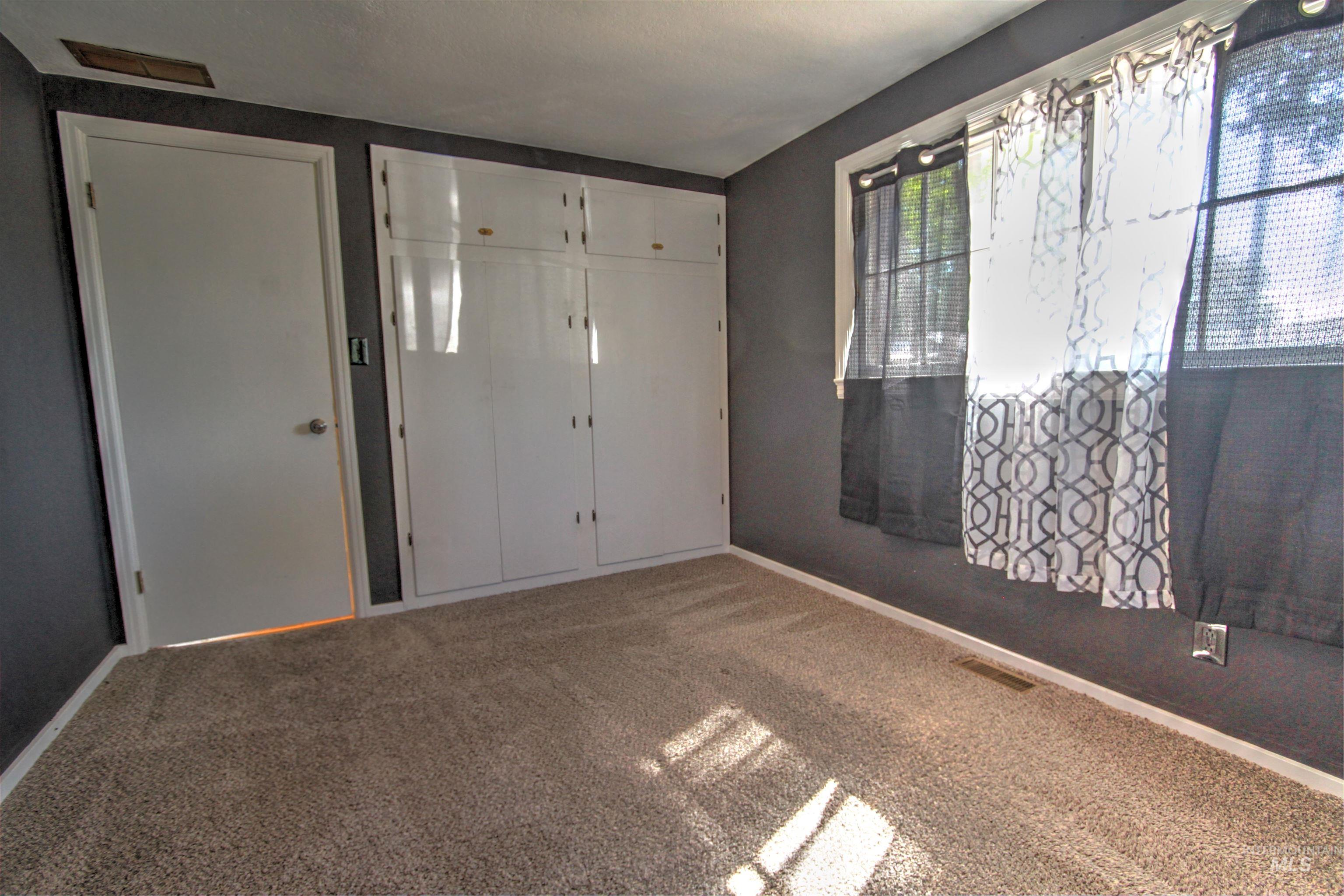 Unfurnished bedroom featuring carpet flooring and a closet