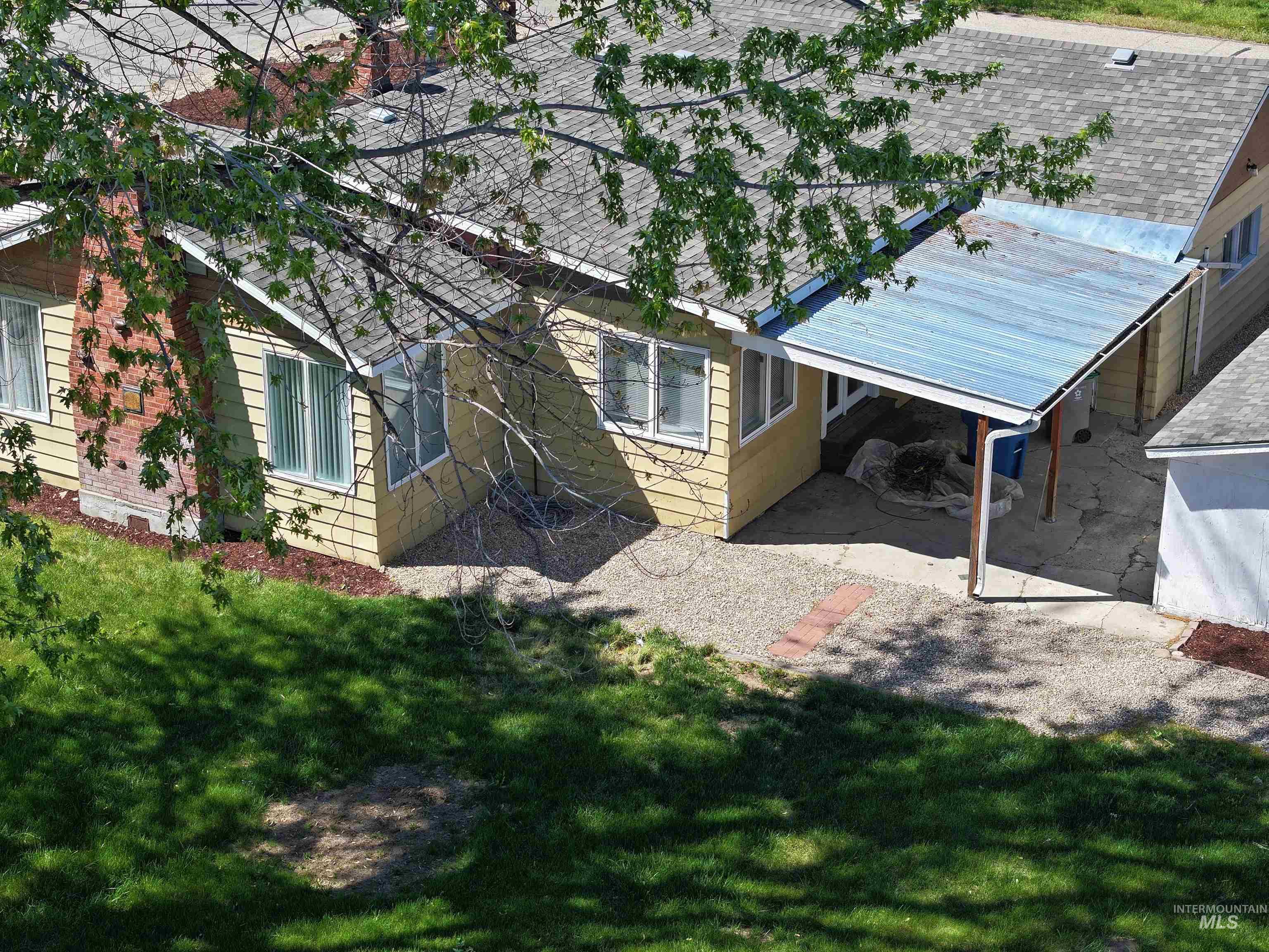 Rear view of house featuring a lawn